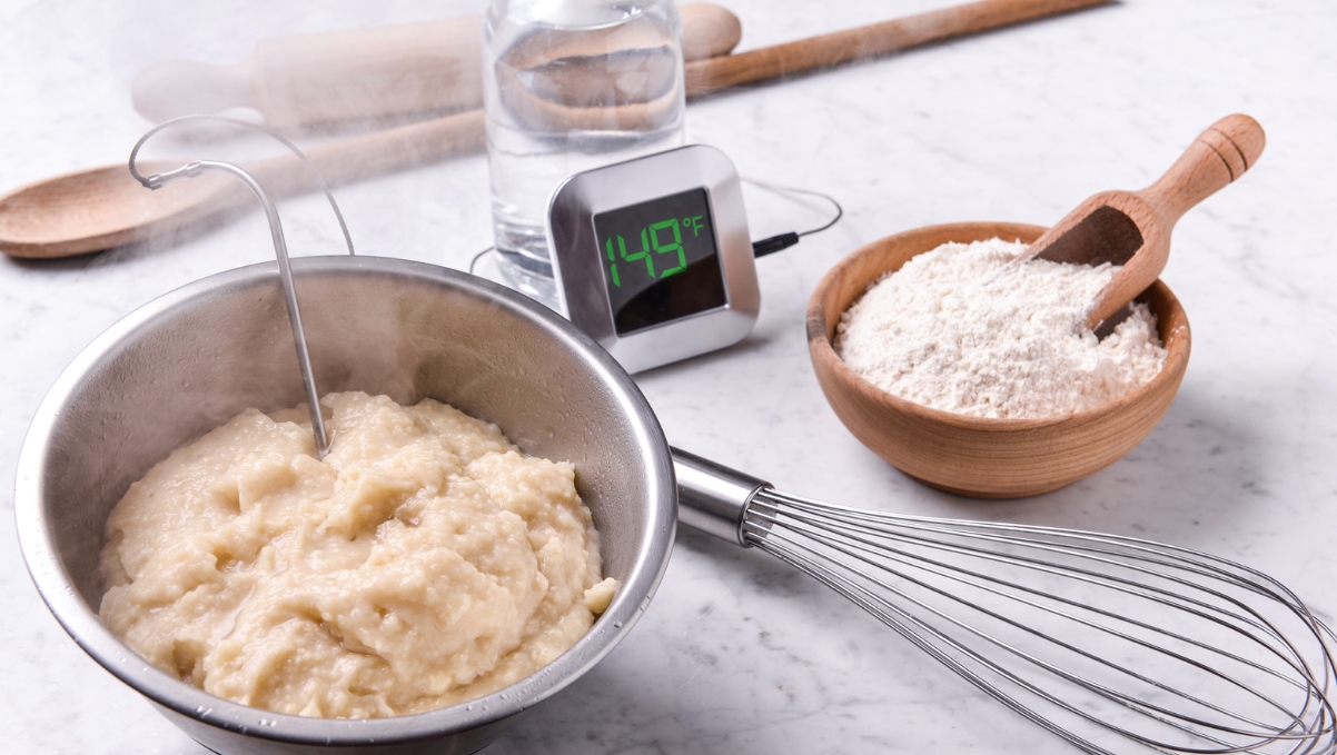 a bowl of dough and a whisk next to a digital thermometer: Water Roux